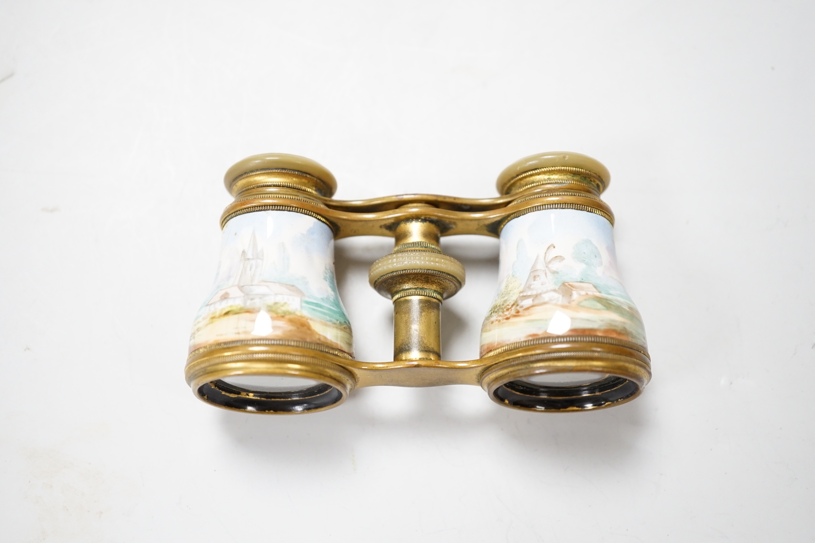 A pair of gilt brass and enamelled opera glasses and a similar pair of mother-of-pearl veneered opera glasses